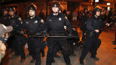 Oakland police officers stand guard